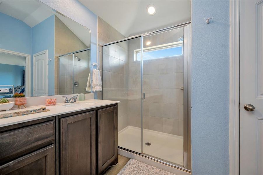 Full bathroom featuring vanity, a stall shower, and ensuite bathroom