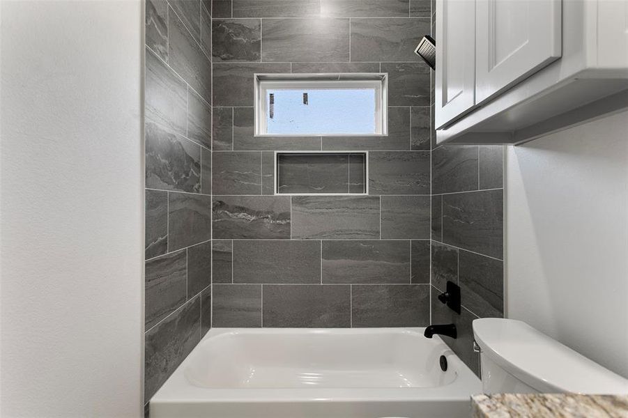 Bathroom with toilet and bathtub / shower combination