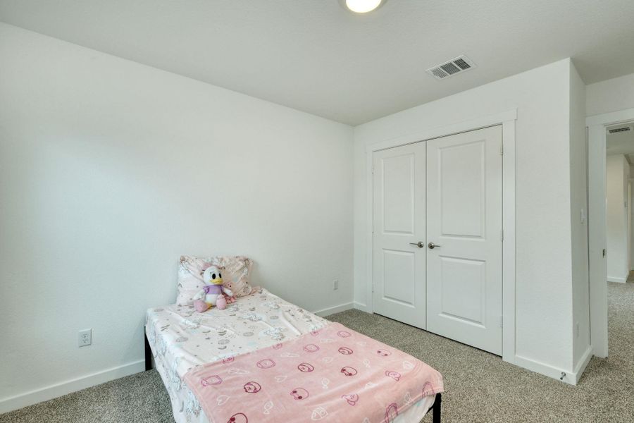 Bedroom featuring a closet, carpet flooring, and baseboards