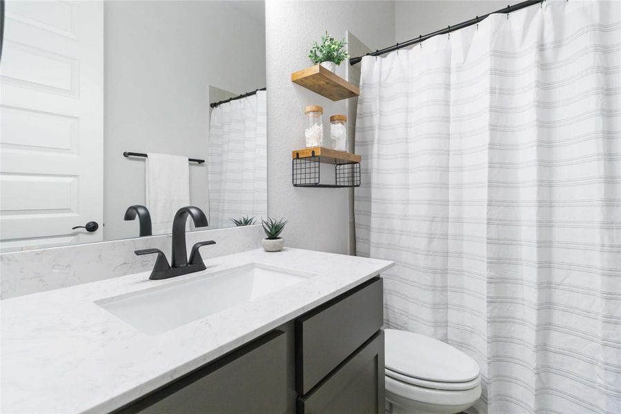 Bathroom with a shower with curtain and vanity Bathroom with a shower with curtain and vanity