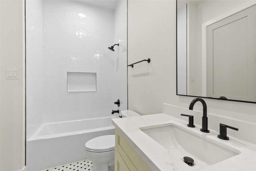 Your secondary bathroom makes mornings easy with a sleek vanity, modern fixtures, and a tub/shower combination perfect for guests or family.