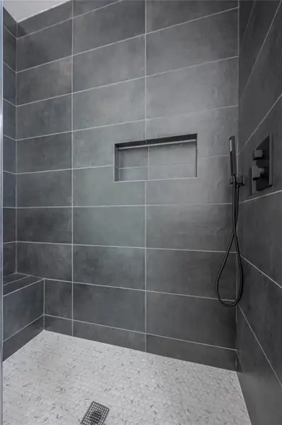 Full bath featuring tiled shower