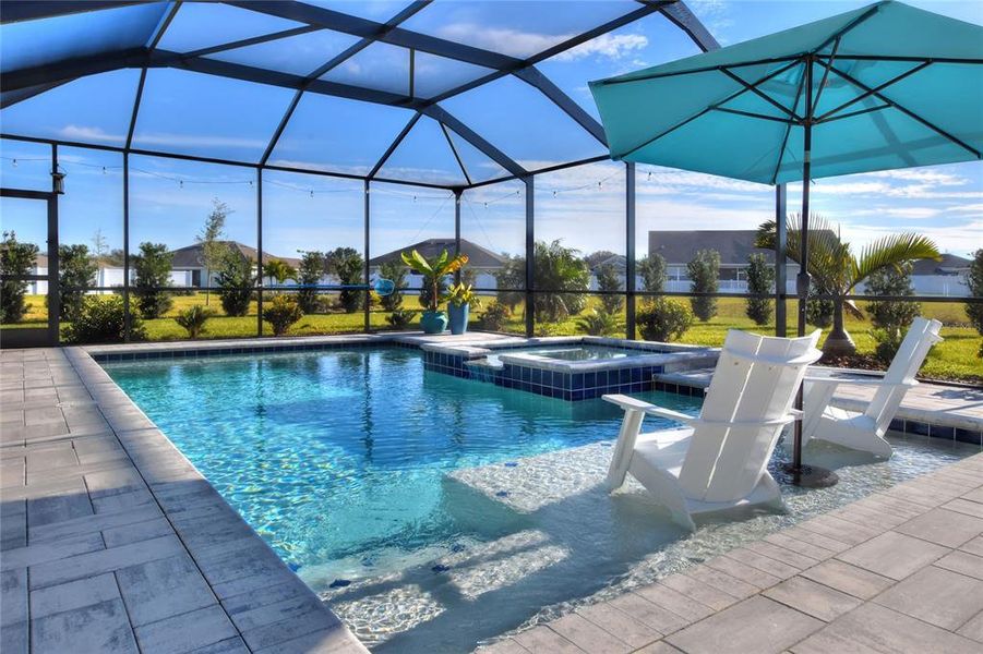 Enclosed heated saltwater pool, with tanning ledge and jacuzzi.