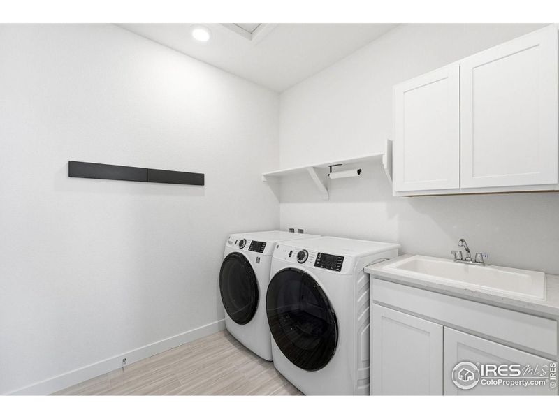 Upper-level laundry room with built-in cabinetry - practical, organized, and easy to use (washer and dryer included)