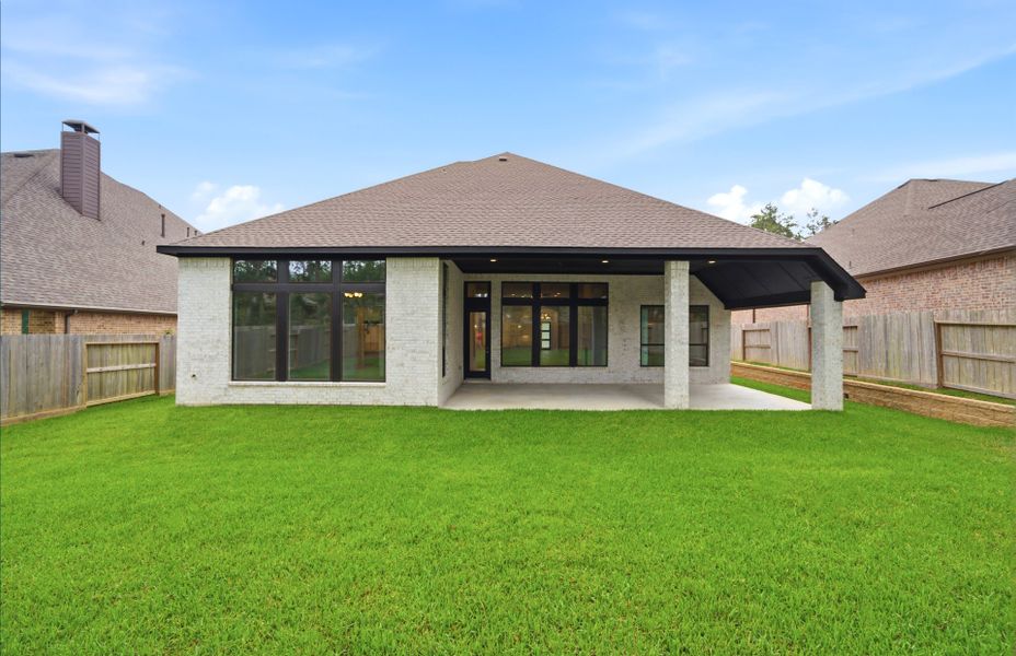 Exterior details and patio area of a home in The Woodlands Hills 65′, Willis (Image 27).