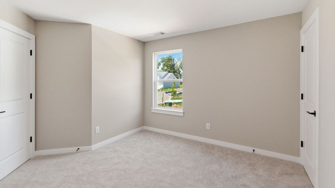 Bedroom with carpet and window