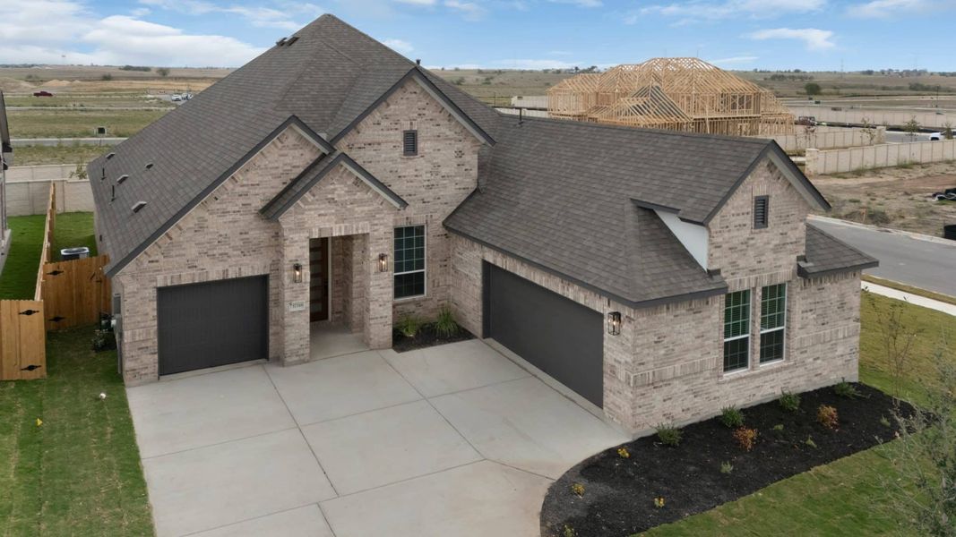 Front exterior of a new home in The Grove at Blackhawk, Pflugerville, TX, highlighting curb appeal (Image 24).