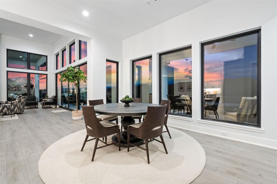 . A dramatic floor-to-ceiling stone fireplace anchors the living room while panoramic canyon views provide a spectacular natural backdrop.