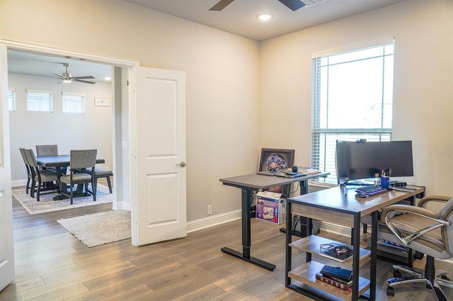 Office space featuring a ceiling fan, wood finished floors, and recessed lighting