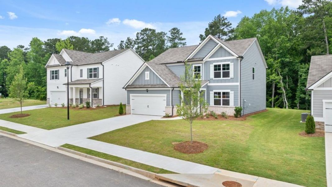Front exterior of a new home in South Wind, Union City, GA, highlighting curb appeal (Image 2). Front exterior of a new home in South Wind, Union City, GA, highlighting curb appeal (Image 2).