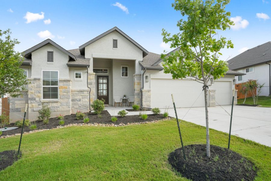 A well-maintained lawn and tasteful landscaping complement this charming facade, featuring an inviting front porch.