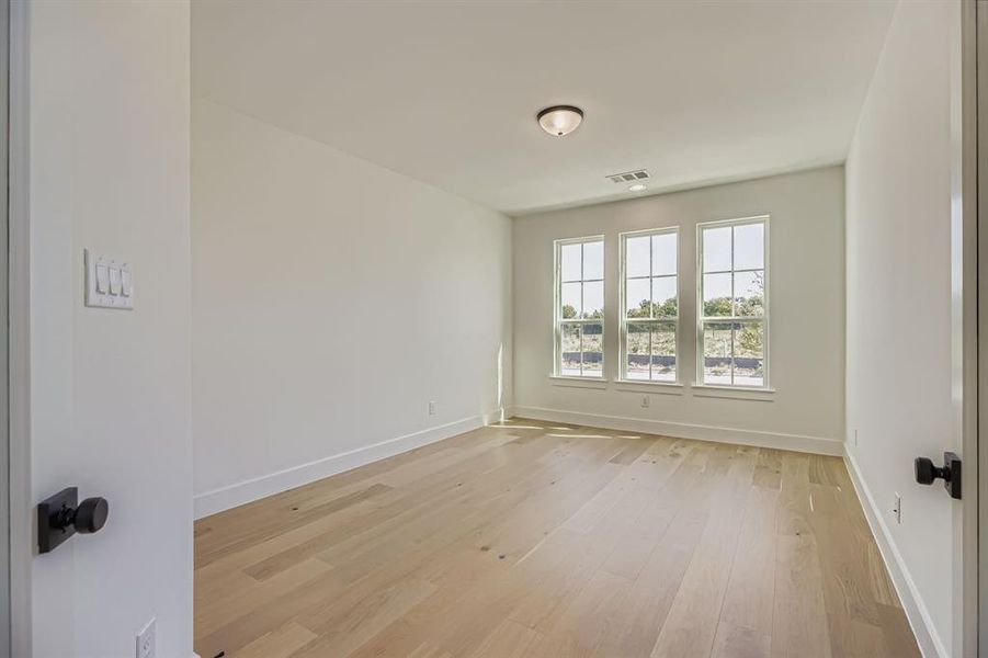Unfurnished room with light wood-style flooring
