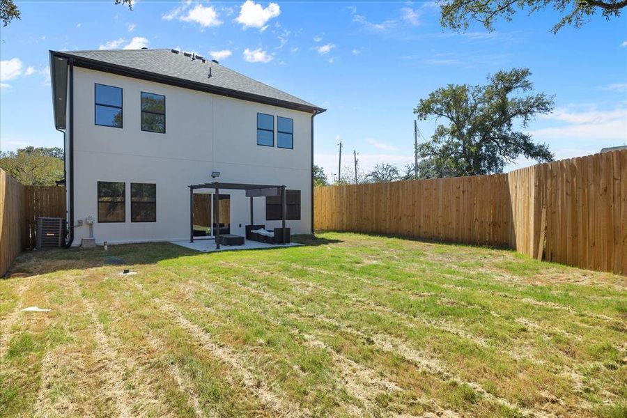 Back of house featuring a patio and a lawn