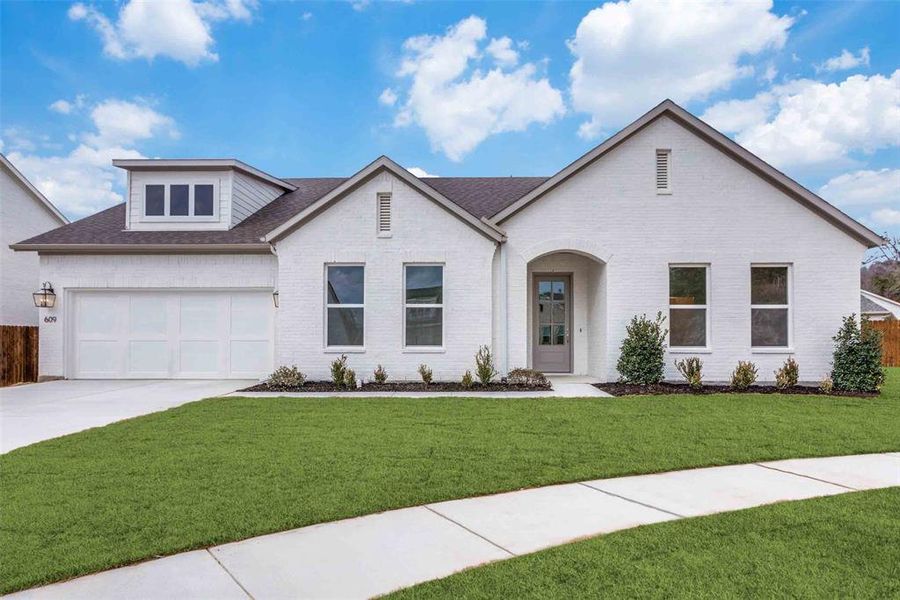 View of front of home featuring a garage and a front lawn