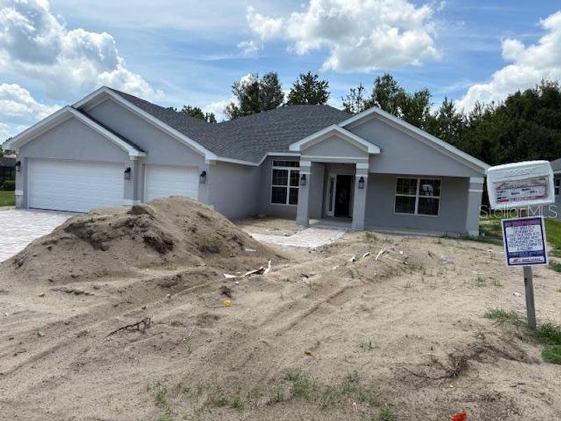 Front exterior of a new home in Juliette Falls, Dunnellon, FL, highlighting curb appeal (Image 7).