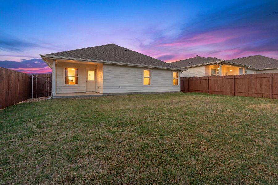 Back of house with a patio area, a fenced backyard, and a shingled roof Back of house with a patio area, a fenced backyard, and a shingled roof