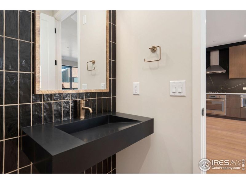 Modern floating sink with tile surround in half bath