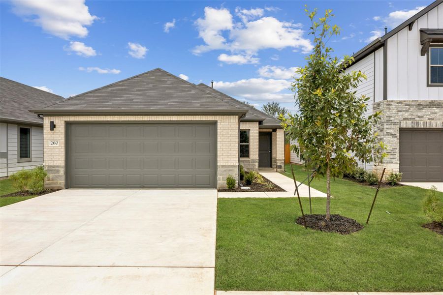 View of front of property featuring a garage, driveway, a front lawn, brick siding, and a shingled roof View of front of property featuring a garage, driveway, a front lawn, brick siding, and a shingled roof
