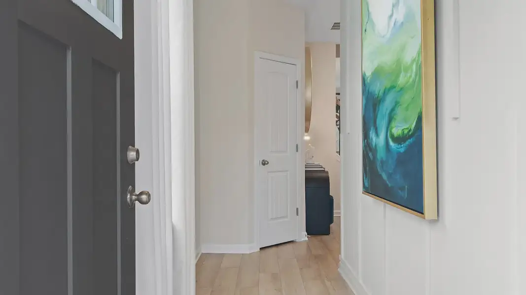 Inviting entryway of new construction townhome in Auburn Ridge featuring stylish trim and modern entry design.