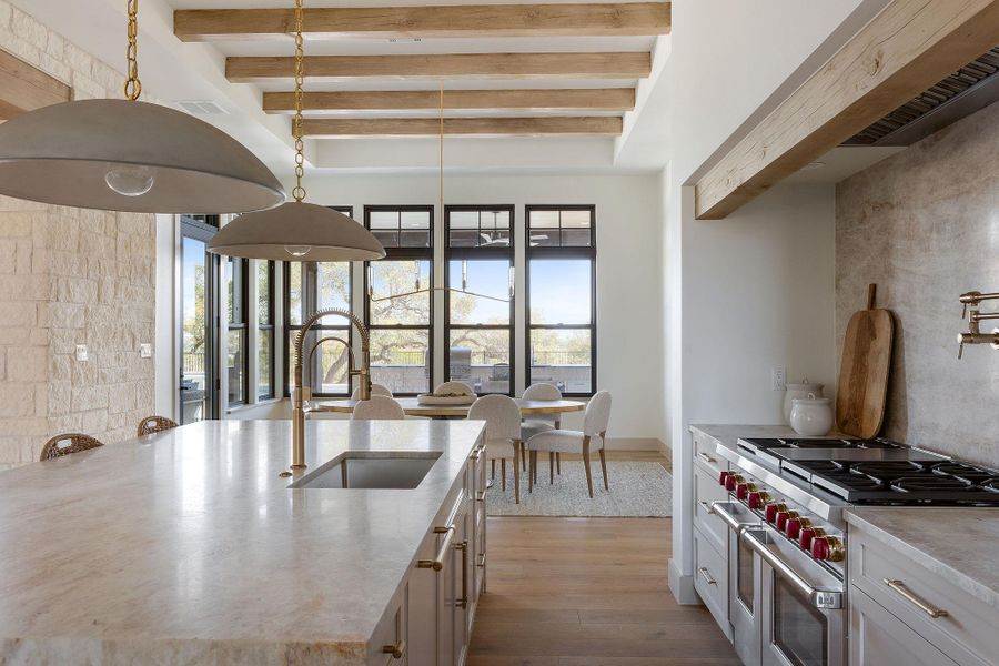 Beautiful gourmet kitchen with waterfall island looking towards dining area