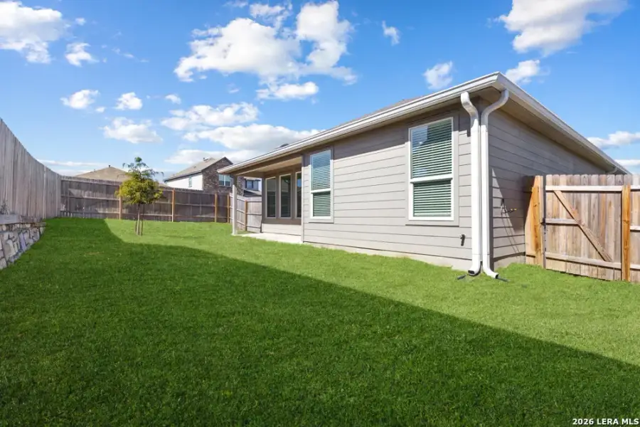 Exterior details and patio area of a home in Hightop Ridge, Converse (Image 32).