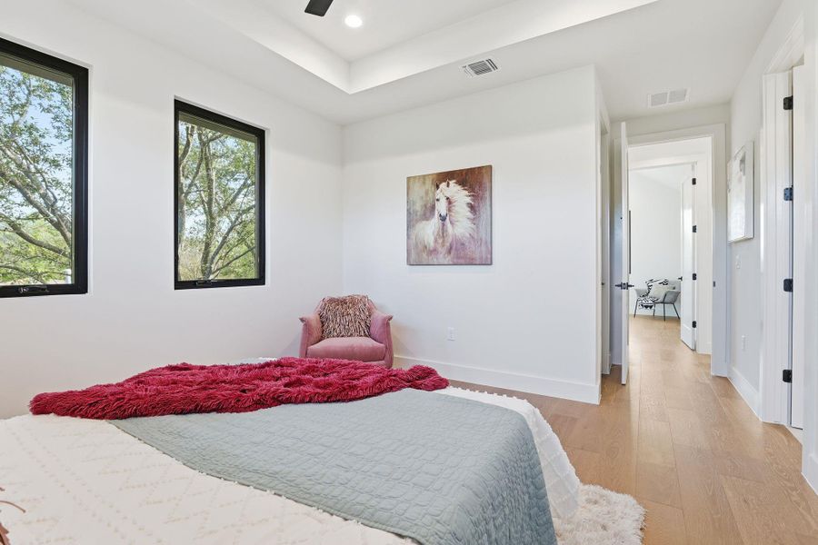 Bedroom with wood finished floors, ceiling fan, and recessed lighting Bedroom with wood finished floors, ceiling fan, and recessed lighting