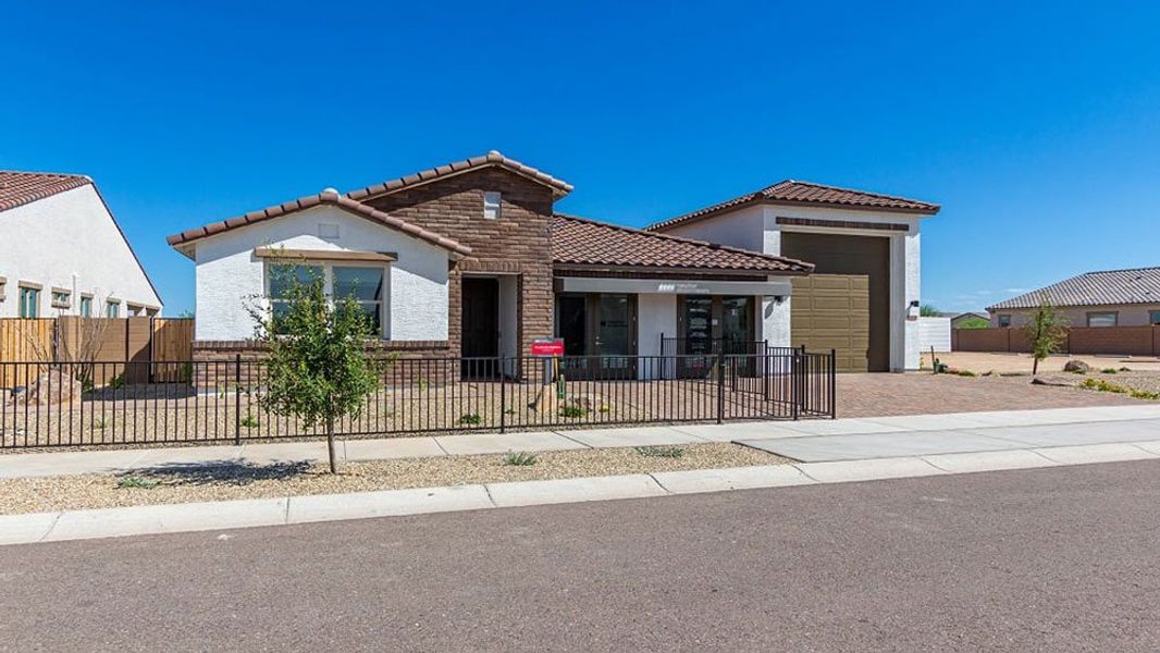 Front exterior of a home in the Los Cielos at Rancho Mercado community, located in Surprise, AZ (Image 20).