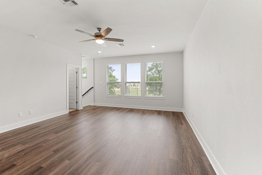 Unfurnished room with baseboards, dark wood-type flooring, a ceiling fan, and recessed lighting Unfurnished room with baseboards, dark wood-type flooring, a ceiling fan, and recessed lighting