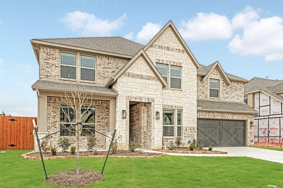 View of front of home featuring a shingled roof, driveway, an attached garage, and brick siding