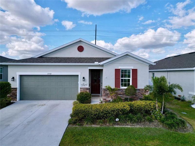 Front exterior of a new home in Seasons at Heritage Square, Haines City, FL, highlighting curb appeal (Image 27). Front exterior of a new home in Seasons at Heritage Square, Haines City, FL, highlighting curb appeal (Image 27).