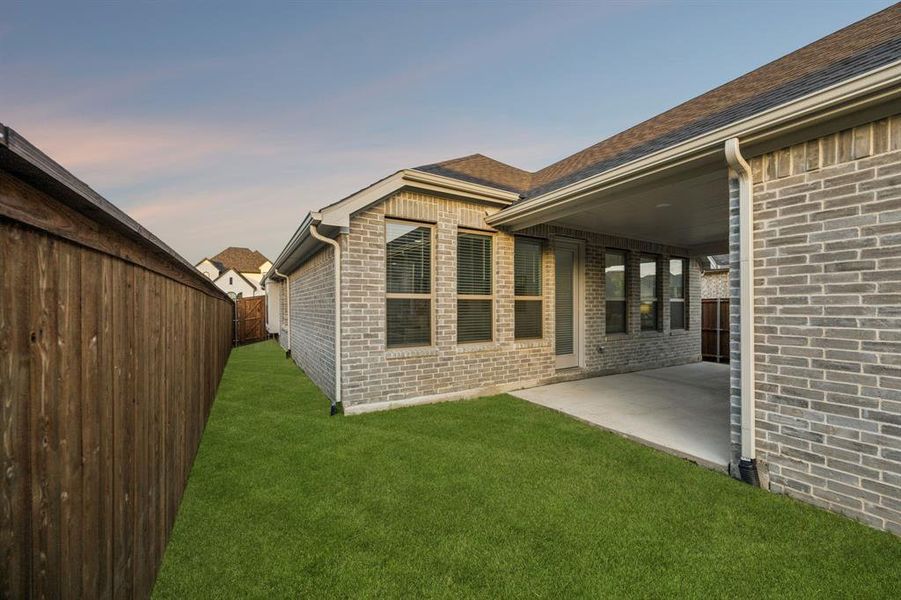Exterior details and patio area of a home in Cambridge Crossing, Celina (Image 25).