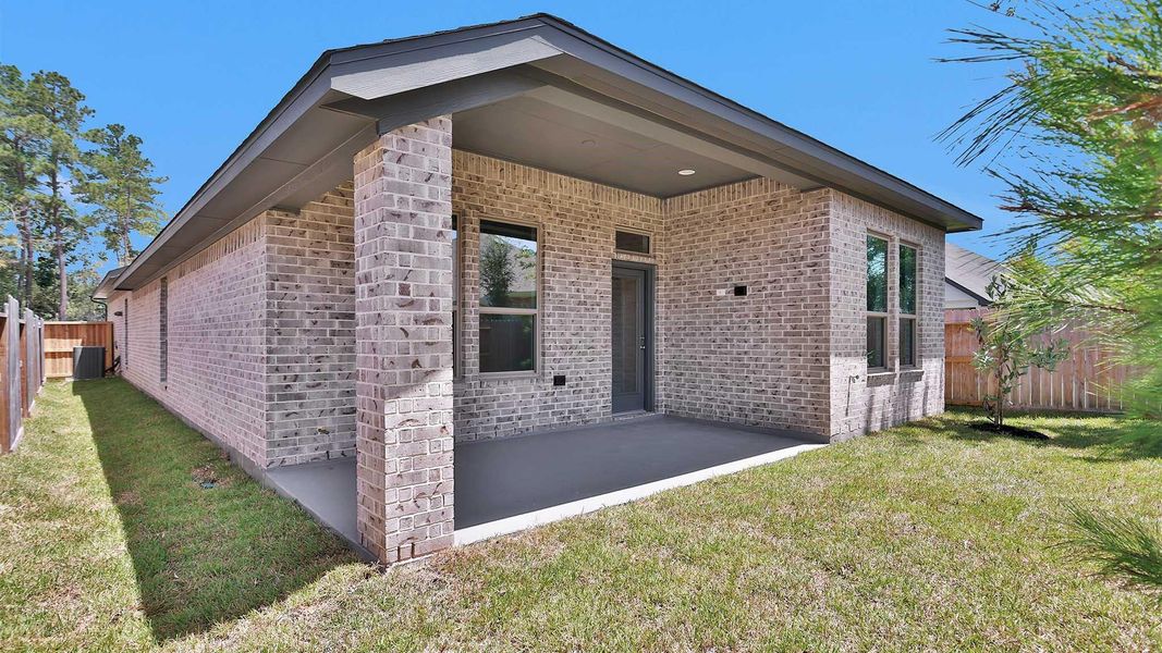 Exterior details and patio area of a home in The Woodlands Hills, Willis (Image 3).