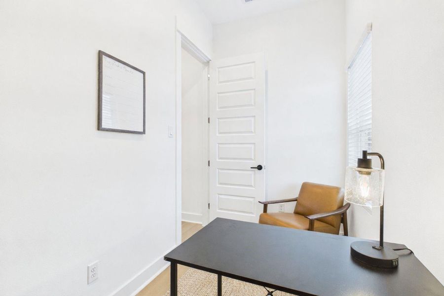 This independent study, conveniently located just off the kitchen, offers a quiet and functional space ideal for a home office, reading room, or creative workspace.
