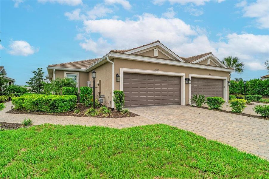Front exterior of a new home in Esplanade at Azario Lakewood Ranch, Lakewood Ranch, FL, highlighting curb appeal (Image 1). Front exterior of a new home in Esplanade at Azario Lakewood Ranch, Lakewood Ranch, FL, highlighting curb appeal (Image 1).