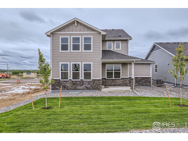 Front exterior of a new home in Barefoot Lakes, Longmont, CO, highlighting curb appeal (Image 1).