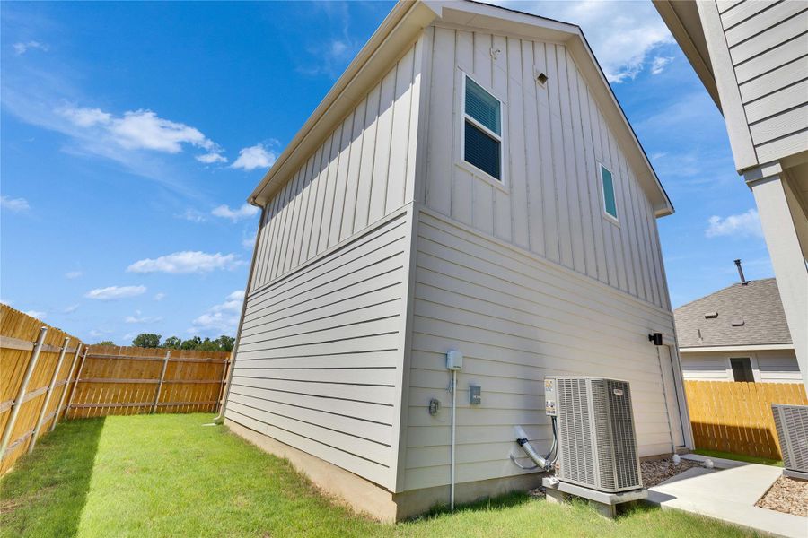 Back of house featuring a fenced backyard and board and batten siding Back of house featuring a fenced backyard and board and batten siding