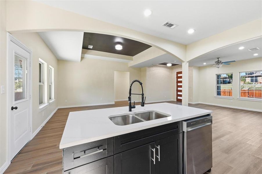 Kitchen featuring arched walkways, open floor plan, light wood-style floors, and recessed lighting Kitchen featuring arched walkways, open floor plan, light wood-style floors, and recessed lighting
