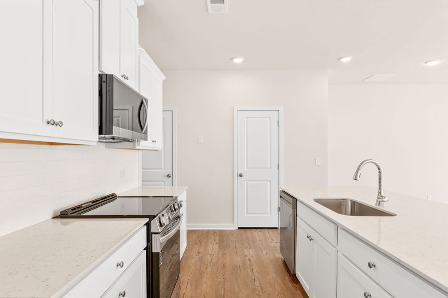 A kitchen with white cabinets. A kitchen with white cabinets.