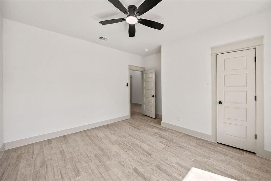 Unfurnished bedroom with light wood-style floors and ceiling fan