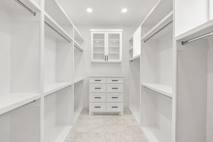 The primary walk-in closet - all bedrooms come with custom walk-in closets built to help you stay well organized.