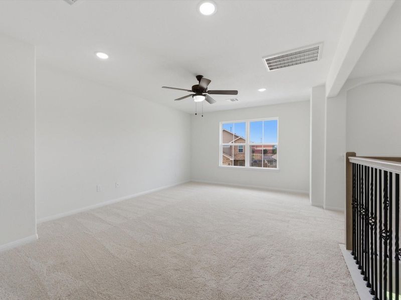The upstairs game room offers a versatile second living space, perfect for movie nights, play, or a comfortable retreat.