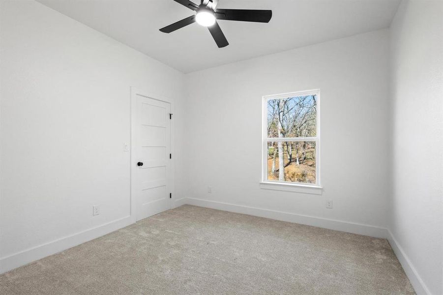 Unfurnished room with carpet floors and ceiling fan