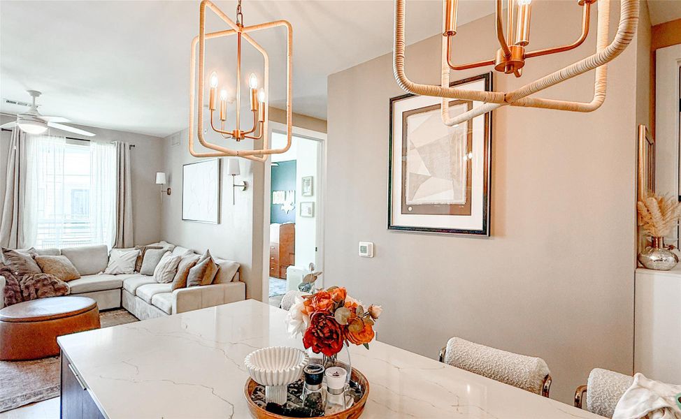 Dining space featuring a ceiling fan and hanging lights