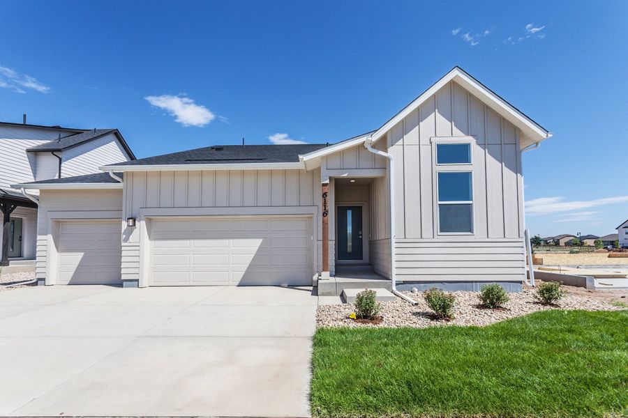 Front exterior of a new home in Trailside, Timnath, CO, highlighting curb appeal (Image 2). Front exterior of a new home in Trailside, Timnath, CO, highlighting curb appeal (Image 2).