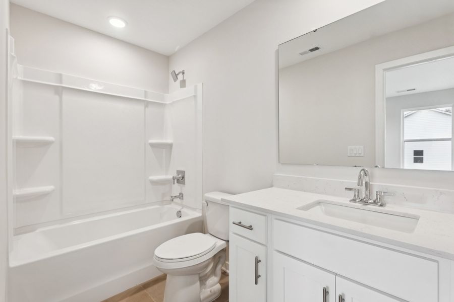 A bathroom with a tub sink and toilet. A bathroom with a tub sink and toilet.