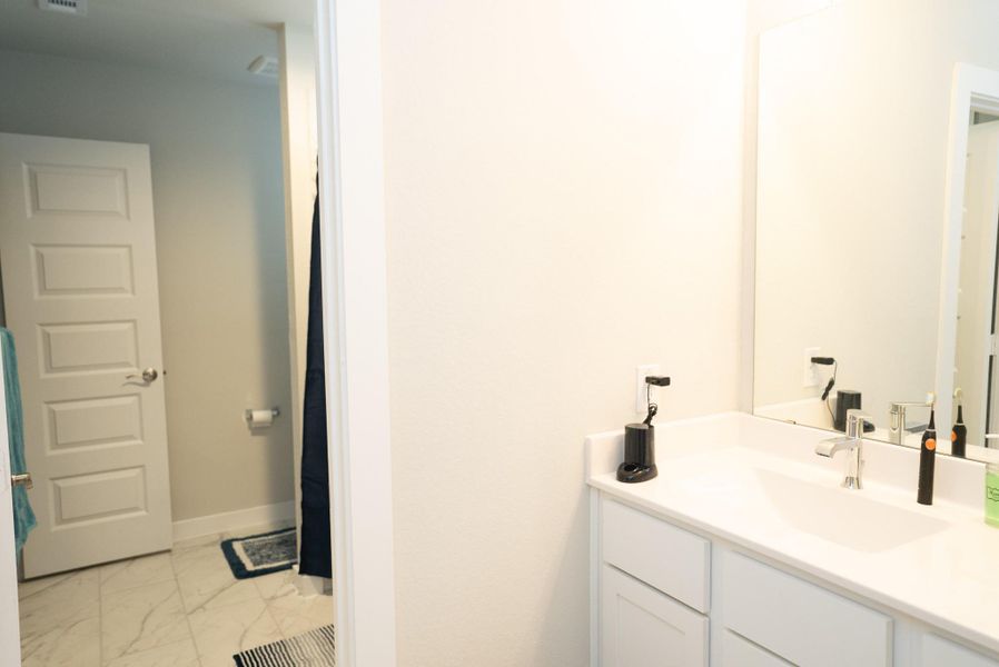 Furnished interior view inside a new home in Sunterra, Katy (Image 11).