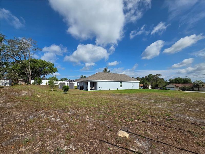 Exterior details and patio area of a home in Hernando County Spot Lots, Spring Hill (Image 26).