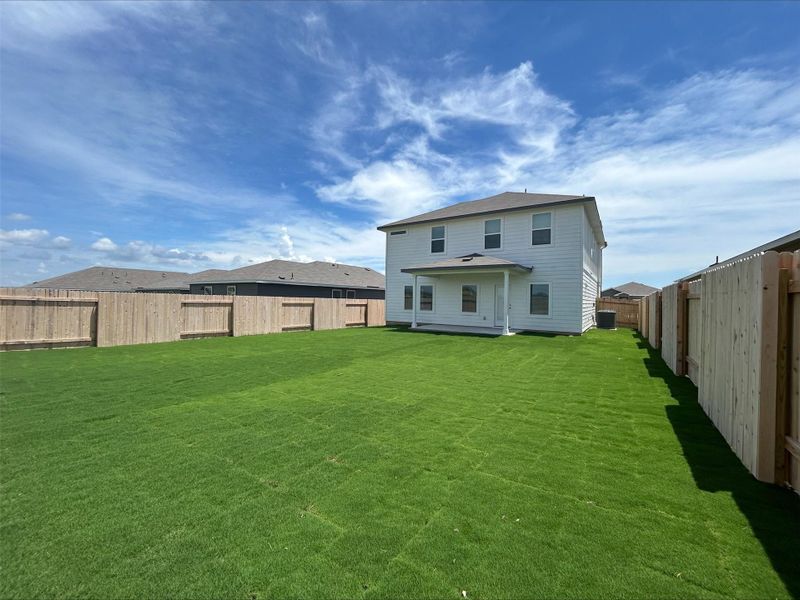 Rear view of house with a fenced backyard and a patio area Rear view of house with a fenced backyard and a patio area