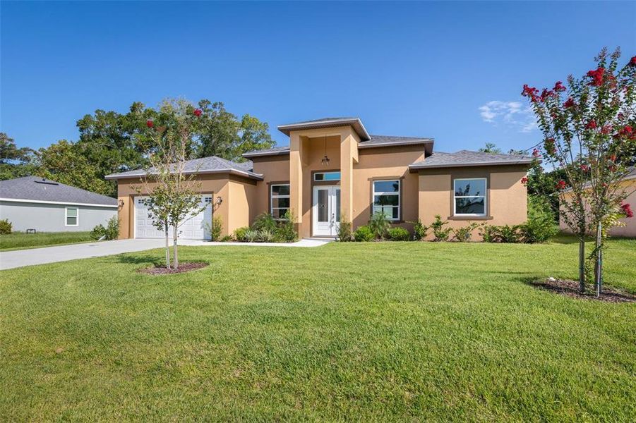 Front exterior of a new home in , Palm Coast, FL, highlighting curb appeal (Image 27).