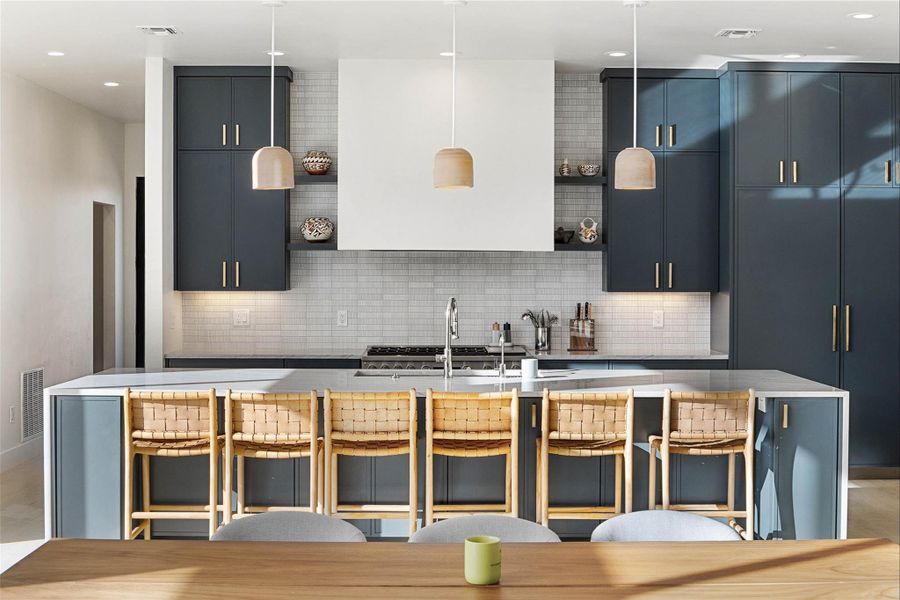 Kitchen with a large island, pendant lighting, a kitchen bar, decorative backsplash, and recessed lighting